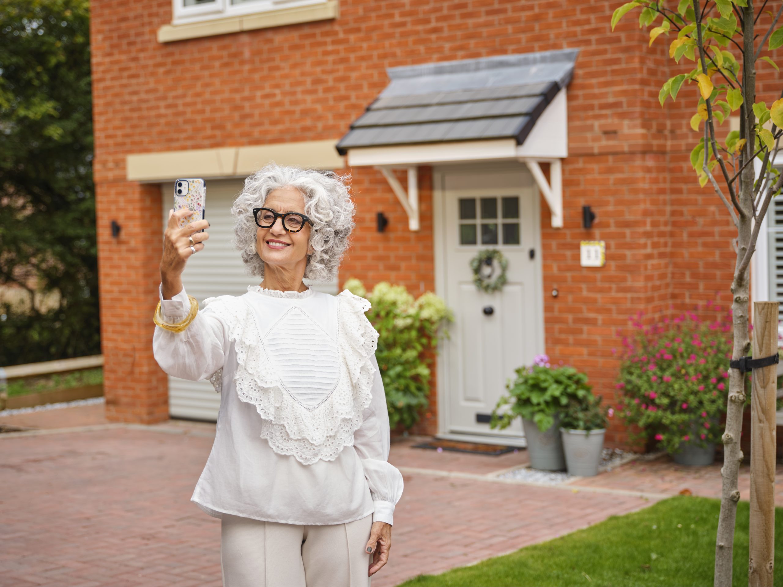 Homeowner taking a selfie in front of their house - BS15Doors & Windows